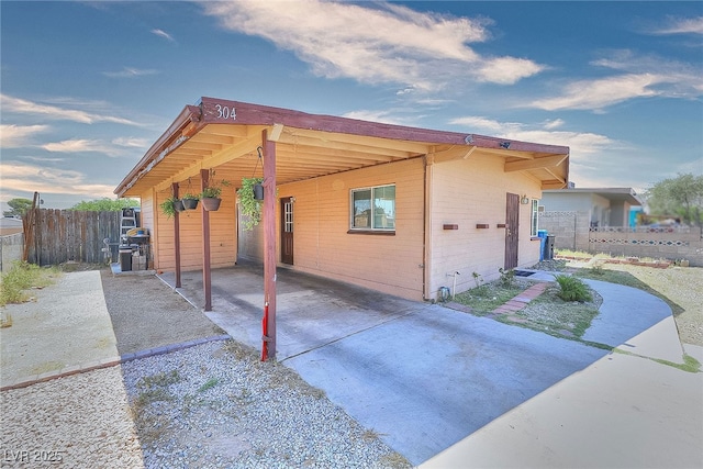 304 N Minnesota St, Las Vegas, NV 89107 - view of side of property featuring an attached carport and concrete driveway