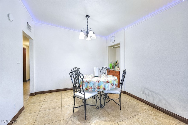 304 N Minnesota St, Las Vegas, NV 89107 - dining area featuring crown molding, a chandelier, light tile patterned flooring, and a textured wall