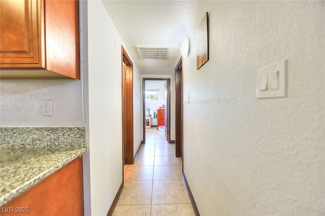 304 N Minnesota St, Las Vegas, NV 89107 - hallway featuring light tile patterned flooring and a textured wall