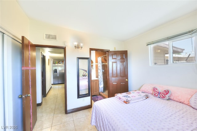 304 N Minnesota St, Las Vegas, NV 89107 - bedroom featuring stainless steel fridge with ice dispenser and light tile patterned flooring