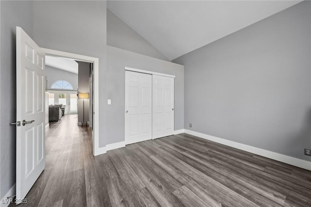 9405 Crosspointe Ave, Las Vegas, NV 89117 - unfurnished bedroom featuring dark wood-style flooring, high vaulted ceiling, and a closet