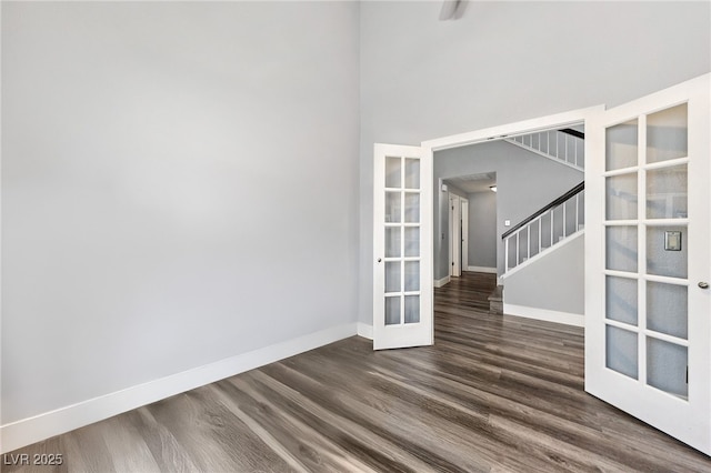 9405 Crosspointe Ave, Las Vegas, NV 89117 - empty room featuring french doors, dark wood finished floors, and stairs