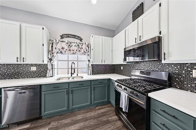 9405 Crosspointe Ave, Las Vegas, NV 89117 - kitchen featuring appliances with stainless steel finishes, lofted ceiling, white cabinets, gray cabinetry, and light countertops