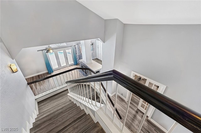 9405 Crosspointe Ave, Las Vegas, NV 89117 - staircase featuring wood finished floors, ceiling fan, and vaulted ceiling