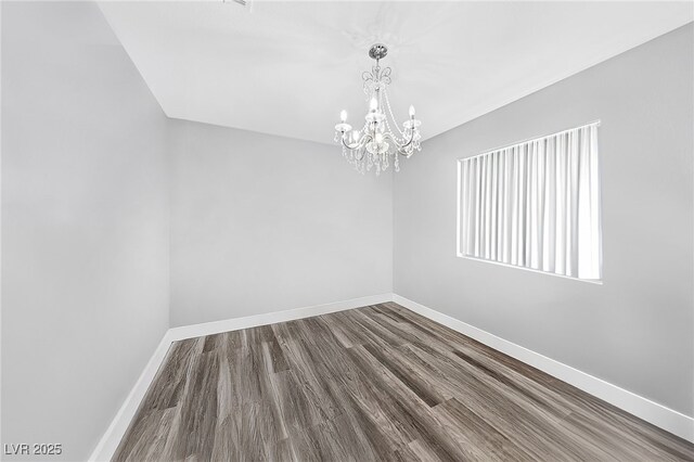 9405 Crosspointe Ave, Las Vegas, NV 89117 - unfurnished room featuring a chandelier and dark wood-type flooring