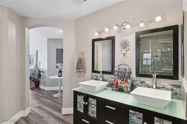 9405 Crosspointe Ave, Las Vegas, NV 89117 - bathroom with double vanity, wood finished floors, a soaking tub, and a shower stall