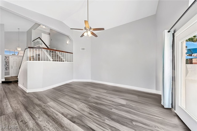 9405 Crosspointe Ave, Las Vegas, NV 89117 - unfurnished living room with wood finished floors, a ceiling fan, healthy amount of natural light, stairway, and high vaulted ceiling