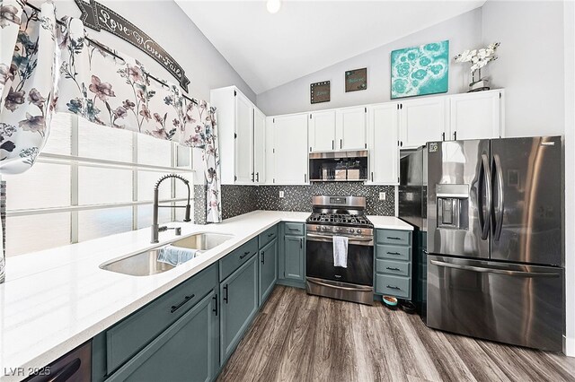 9405 Crosspointe Ave, Las Vegas, NV 89117 - kitchen with appliances with stainless steel finishes, dark wood-type flooring, light countertops, backsplash, and white cabinetry