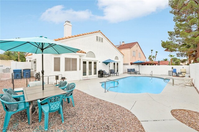 9405 Crosspointe Ave, Las Vegas, NV 89117 - view of pool featuring french doors, a fenced backyard, a patio, and outdoor dining area