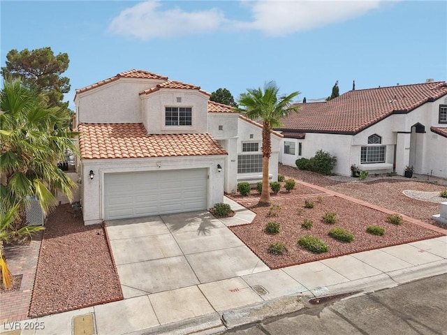 9405 Crosspointe Ave, Las Vegas, NV 89117 - mediterranean / spanish home featuring stucco siding, driveway, a tiled roof, and a garage