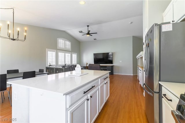 625 Bright Lights Ave, North Las Vegas, NV 89031 - kitchen featuring lofted ceiling, ceiling fan, light wood-type flooring, a chandelier, and white cabinetry