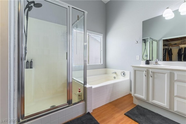 625 Bright Lights Ave, North Las Vegas, NV 89031 - full bath featuring a shower stall, a garden tub, vanity, wood finished floors, and a walk in closet