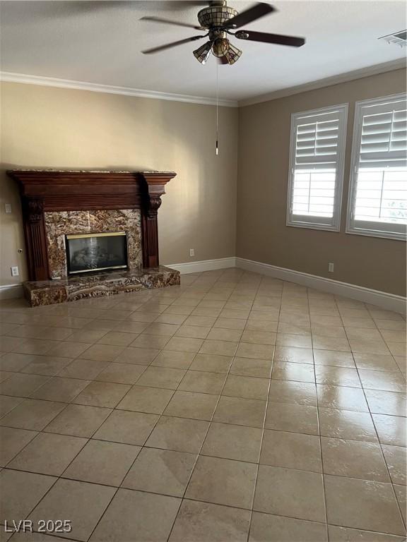 11004 Mount Royal Ave, Las Vegas, NV 89144 - unfurnished living room featuring ornamental molding, ceiling fan, a premium fireplace, and light tile patterned flooring