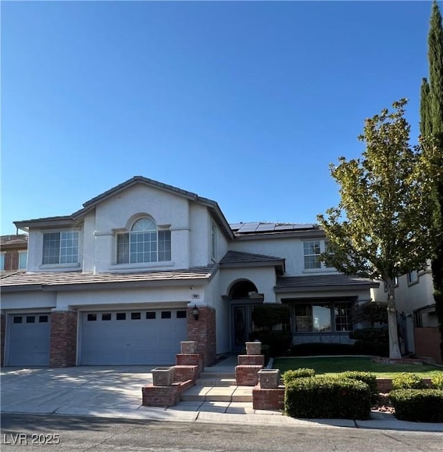 11004 Mount Royal Ave, Las Vegas, NV 89144 - view of front of property featuring an attached garage, solar panels, driveway, and stucco siding