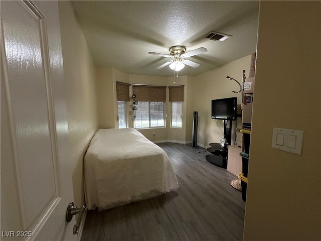5449 Bugle Way Unit 105, Las Vegas, NV 89108 - bedroom with wood finished floors, a ceiling fan, and a textured ceiling