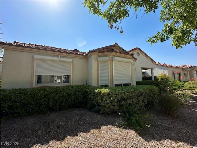 5449 Bugle Way Unit 105, Las Vegas, NV 89108 - view of side of property featuring stucco siding and a tile roof