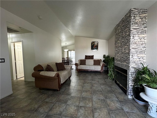 5449 Bugle Way Unit 105, Las Vegas, NV 89108 - living area featuring lofted ceiling and a stone fireplace