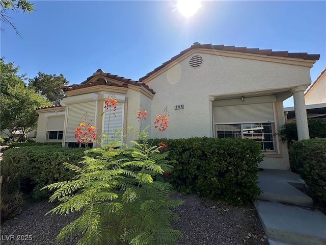 5449 Bugle Way Unit 105, Las Vegas, NV 89108 - view of front of house featuring stucco siding and a tiled roof