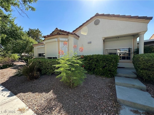 5449 Bugle Way Unit 105, Las Vegas, NV 89108 - view of front of property with stucco siding and a tile roof
