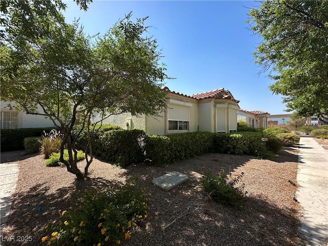 5449 Bugle Way Unit 105, Las Vegas, NV 89108 - view of property exterior with stucco siding and a tile roof