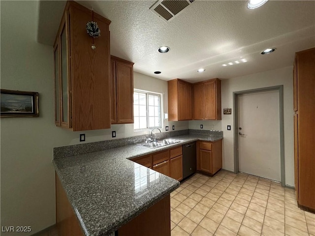 5449 Bugle Way Unit 105, Las Vegas, NV 89108 - kitchen with dishwasher, a peninsula, brown cabinets, a textured ceiling, and recessed lighting