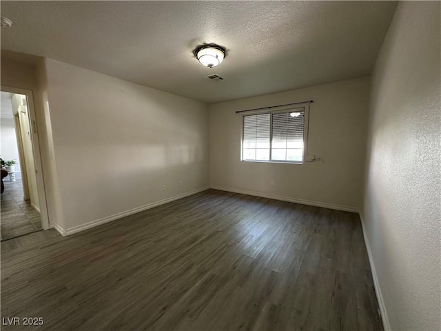 5449 Bugle Way Unit 105, Las Vegas, NV 89108 - spare room featuring dark wood-style floors and a textured ceiling