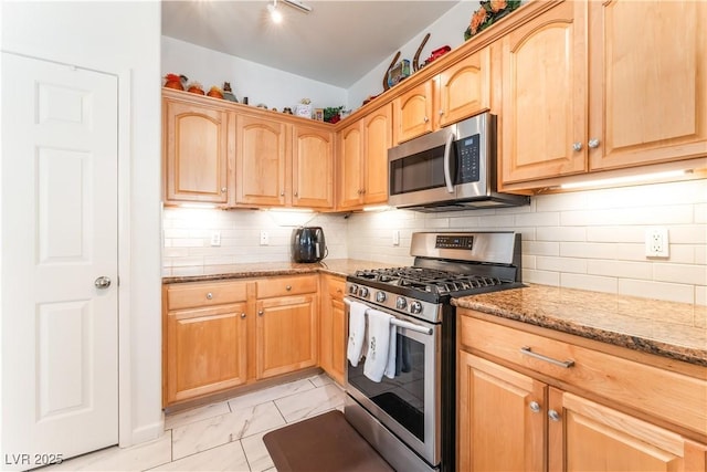 6312 Beige Bluff St Unit 102, North Las Vegas, NV 89081 - kitchen featuring stainless steel appliances, light marble finish floors, light stone counters, light brown cabinets, and backsplash