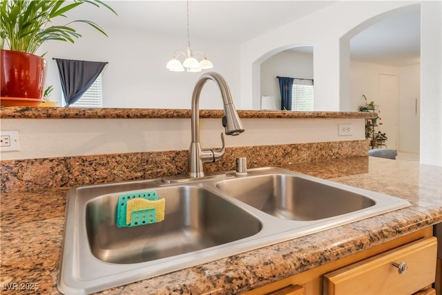 6312 Beige Bluff St Unit 102, North Las Vegas, NV 89081 - kitchen view of arched walkways, pendant lighting, and a chandelier