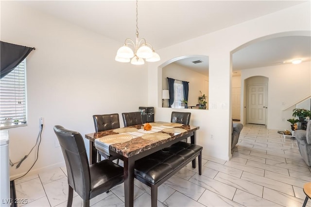6312 Beige Bluff St Unit 102, North Las Vegas, NV 89081 - dining area with arched walkways, light marble finish floors, and a chandelier