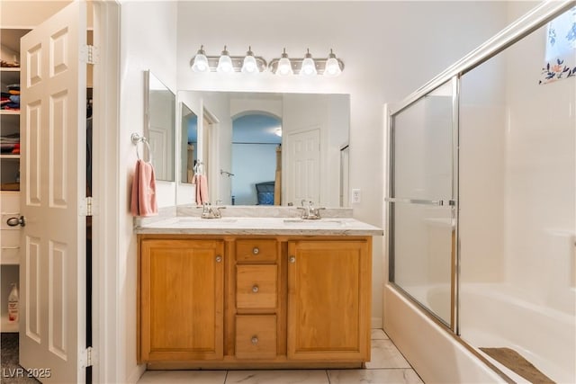 6312 Beige Bluff St Unit 102, North Las Vegas, NV 89081 - bathroom with double vanity and combined bath / shower with glass door