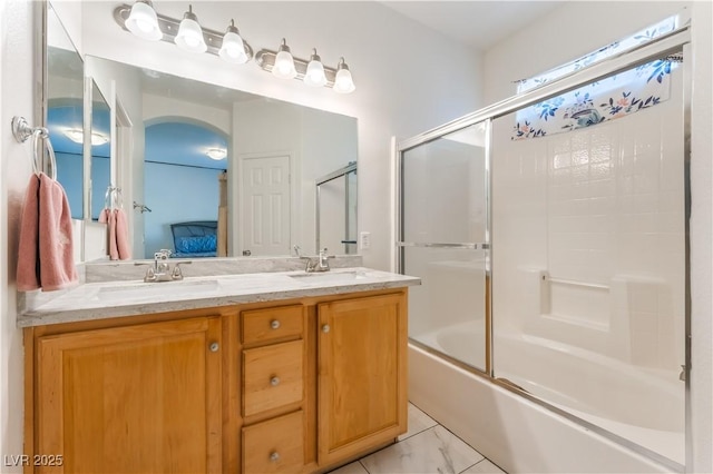 6312 Beige Bluff St Unit 102, North Las Vegas, NV 89081 - ensuite bathroom with double vanity and enclosed tub / shower combo