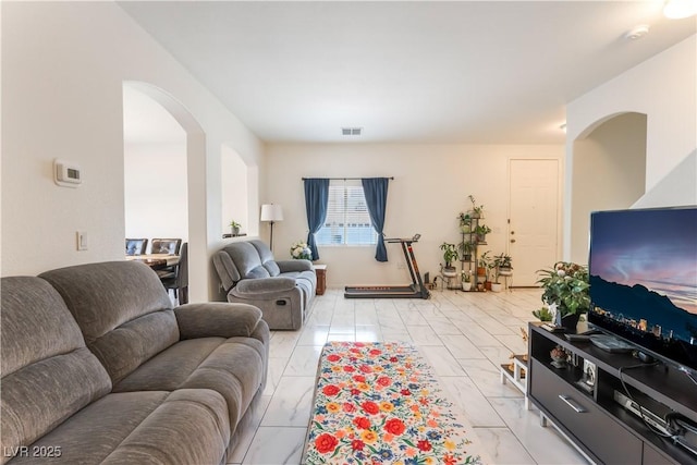 6312 Beige Bluff St Unit 102, North Las Vegas, NV 89081 - living area featuring arched walkways and light marble finish floors