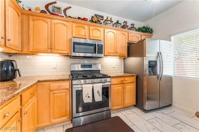 6312 Beige Bluff St Unit 102, North Las Vegas, NV 89081 - kitchen with appliances with stainless steel finishes, light marble finish floors, plenty of natural light, and light stone countertops