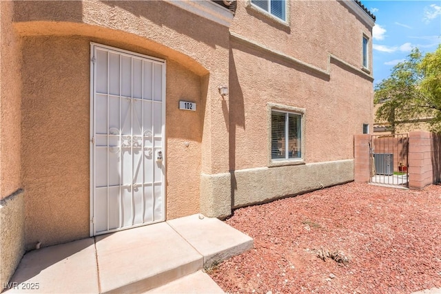 6312 Beige Bluff St Unit 102, North Las Vegas, NV 89081 - entrance to property with stucco siding and a gate