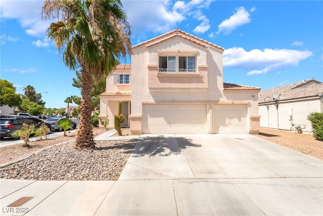 4062 W El Campo Grande Ave, North Las Vegas, NV 89031 - mediterranean / spanish house with a garage, a tiled roof, driveway, and stucco siding