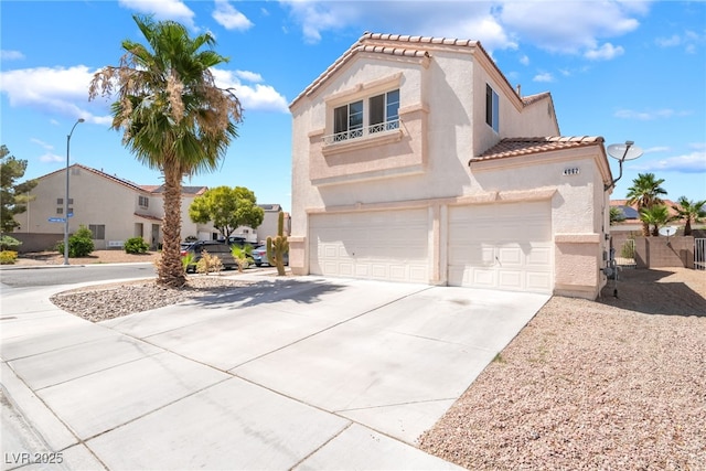 4062 W El Campo Grande Ave, North Las Vegas, NV 89031 - mediterranean / spanish home featuring an attached garage, a tile roof, stucco siding, and driveway