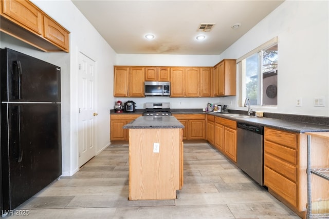 4062 W El Campo Grande Ave, North Las Vegas, NV 89031 - kitchen featuring stainless steel appliances, a kitchen island, dark countertops, light wood finished floors, and recessed lighting