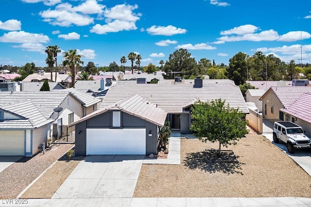 4319 Basil Leaf Ave, North Las Vegas, NV 89031 - view of front of house featuring driveway, an attached garage, a residential view, a tile roof, and brick siding
