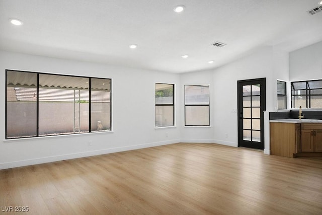 4319 Basil Leaf Ave, North Las Vegas, NV 89031 - empty room featuring light wood-style flooring, healthy amount of natural light, recessed lighting, and vaulted ceiling