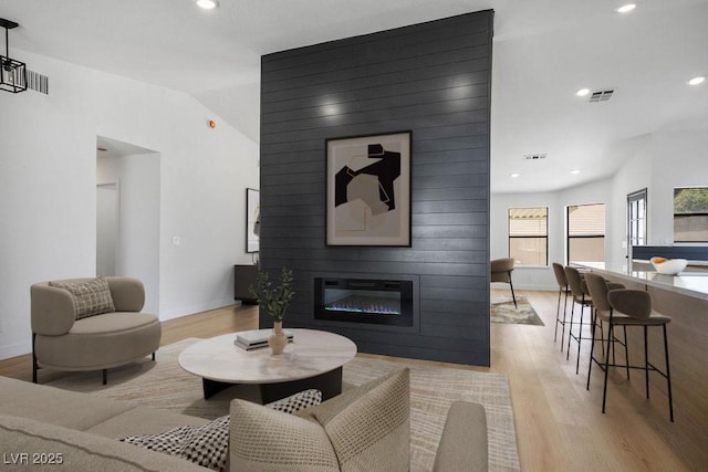 4319 Basil Leaf Ave, North Las Vegas, NV 89031 - living area featuring light wood finished floors, a fireplace, recessed lighting, and vaulted ceiling