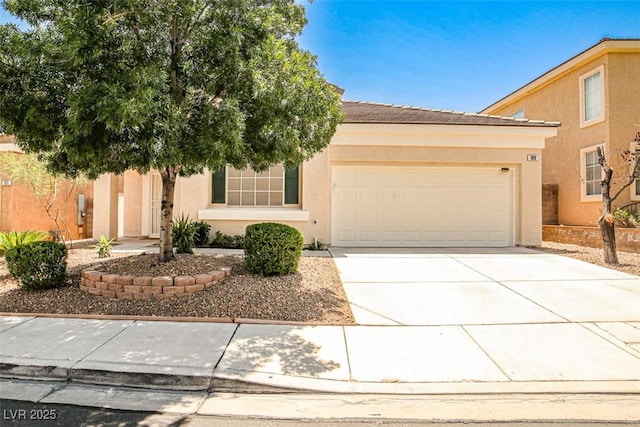 920 Siena Hills Ln, Las Vegas, NV 89144 - view of front of home featuring stucco siding, a garage, and concrete driveway