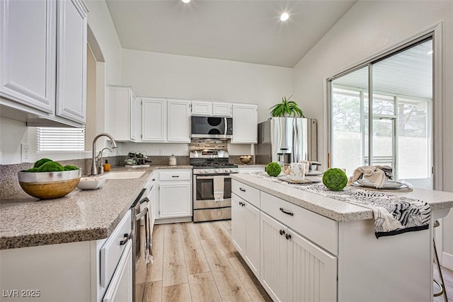 920 Siena Hills Ln, Las Vegas, NV 89144 - kitchen with stainless steel appliances, a kitchen island, light wood-style flooring, healthy amount of natural light, and recessed lighting