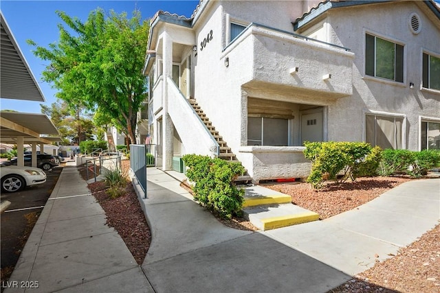 3042 Tarpon Dr Unit 202, Las Vegas, NV 89120 - view of side of home featuring stucco siding and stairway