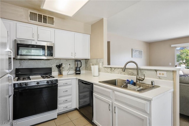 3042 Tarpon Dr Unit 202, Las Vegas, NV 89120 - kitchen with black appliances, a peninsula, and white cabinetry