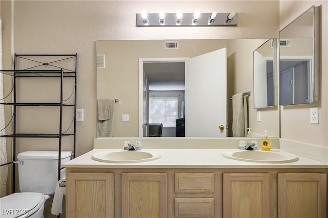 3042 Tarpon Dr Unit 202, Las Vegas, NV 89120 - bathroom featuring double vanity and a textured wall