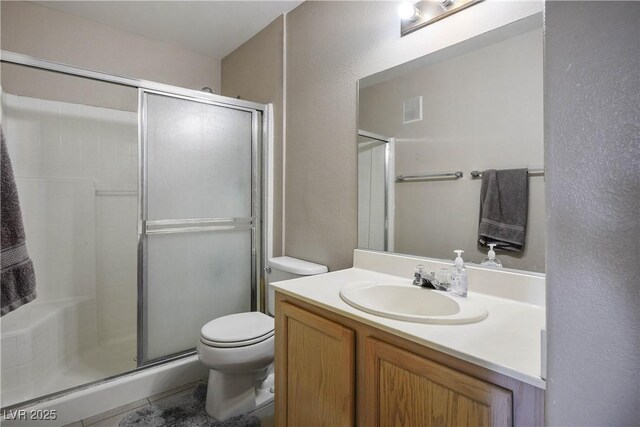 3042 Tarpon Dr Unit 202, Las Vegas, NV 89120 - bathroom with a stall shower, vanity, and a textured wall