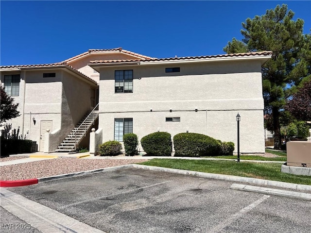 2627 S Durango Dr Unit 202, Las Vegas, NV 89117 - view of property featuring stairs and uncovered parking