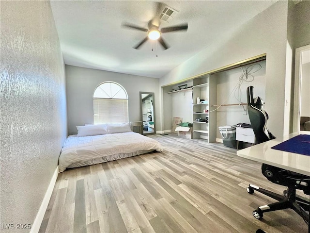 2627 S Durango Dr Unit 202, Las Vegas, NV 89117 - bedroom with wood finished floors, a textured wall, and ceiling fan