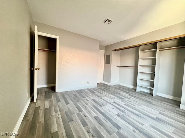 2627 S Durango Dr Unit 202, Las Vegas, NV 89117 - unfurnished bedroom featuring wood finished floors and electric panel