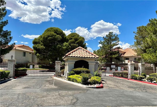 2627 S Durango Dr Unit 202, Las Vegas, NV 89117 - view of asphalt street featuring a gate, a gated entry, curbs, and a residential view